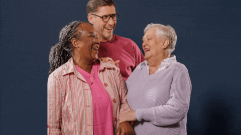 Foto van drie blije mensen van Woonzorg Nederland